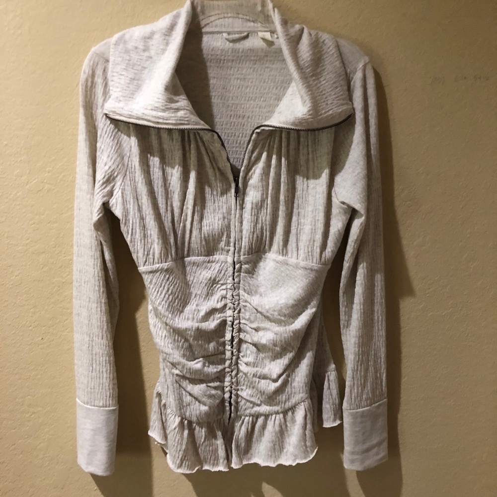 Light over jacket or top. Off white in color